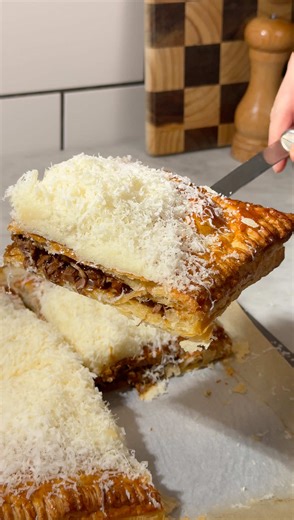 We've been obsessed with parmesan loaded sandwiches, but then we thought PARMESAN-LOADED PIE .... This is what happens when beef shin gets the low and slow treatment. Braised for hours until fall apart tender, simmered into a rich, glossy ragu, then wrapped up in flaky puff pastry with chunky cubes of cheddar hidden inside for those molten, cheesy pockets. It's quite literally perfect. Recipe link in bio, you'll want to make this one #dinner #pie #food #pies #recipe