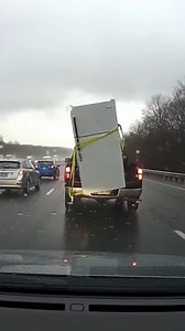 Fridge Falls From Truck on Highway Pittsburgh, Pennsylvania — March 18, 2025 A driver's decision to transport a full-sized refrigerator with a single, inadequate strap led to a heart-stopping moment on a busy Pittsburgh highway Wednesday, creating a massive road hazard that was all captured on a following vehicle's dashcam. The viral video shows a pickup truck driving in the rain with the appliance standing unsecured in the bed. Suddenly, the refrigerator teeters and tips over the tailgate, cras