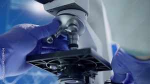 Laboratory equipment. Scientist calibrating the microscope. Close up Stock Video