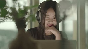 Young Asian Woman Using Computer Inside Apartment At Home