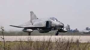Supersonic interceptor fighter jet and bomber takes off. Close-up follow shot