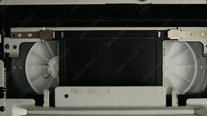 Close-up VHS video cassette recorder inside without tags. Tape inserting, play and than eject. VHS mechanics video cassette player insert tape head. Vintage concept. Rack focus