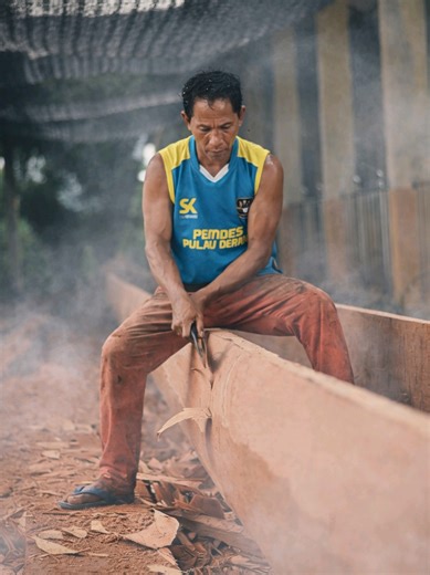 Expert Boat Builder Crafts Long Boat from Large Wood Pieces