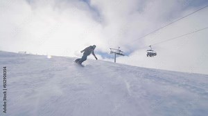 girl snowboarding on slopes. female snowboarder in european ski center. side view.