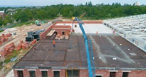 Concrete slab creation. Construction of a new resistance complex, top view. Workers create concrete formwork