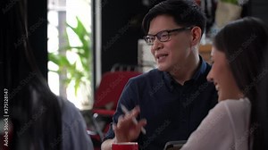 group of young asian business people team meeting at coworking space in modern office discussing business plan and brainstorm . entrepreneurs man Present Strategy to partner woman