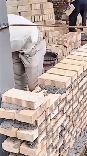 the process of installing red bricks very neatly
