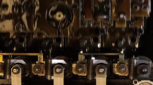 Close-up view of an industrial nozzle system, showing cooling or lubrication tubes and detailed engi