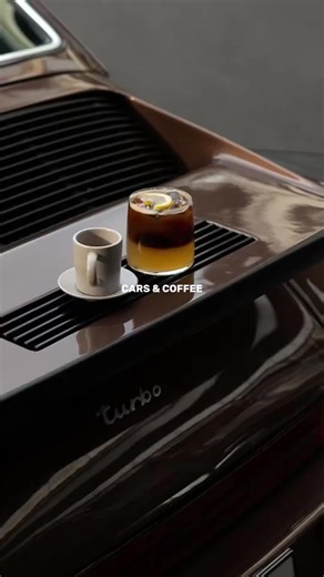 The hood is the table. The engine lid is the bar. The parking lot is the venue. No reservations required. Just a good car, a better coffee, and the kind of Saturday morning that reminds you why weekdays are worth surviving. There's a reason Cars & Coffee has become one of the most beloved looks in modern life. It isn't really about horsepower. It isn't even really about the coffee. It's about showing up to something beautiful, intentionally, on a day when nobody is making you. It's about recogni