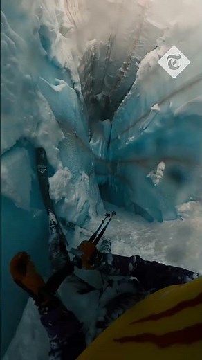 Skier falls down deep glacier cliff and narrowly avoids falling into the abyss