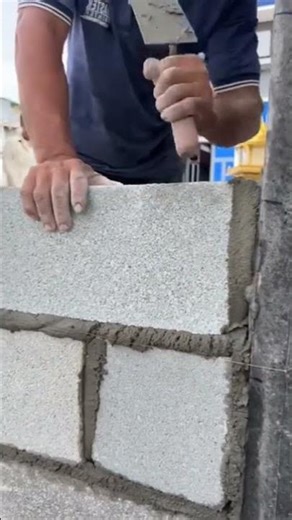 Professional Mason Laying AAC Blocks with Perfect Alignment