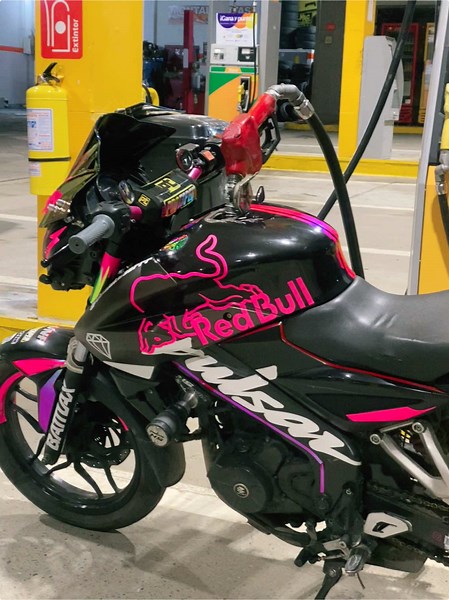 Refueling a Stylish Motorcycle at a Gas Station