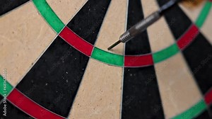 Dart arrow hitting in the target center of dartboard. Triple 19. 4K.