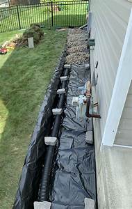 Adding gravel and pipe to a French drain