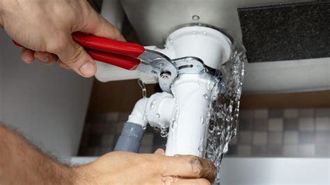 Plumber fixing burst pipe