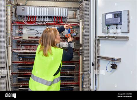 Electrician working on fuse box