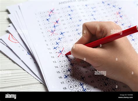 Teacher checking exam paper