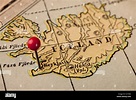 Iceland on vintage 1920s map with a red pushpin on Reykjavik, selective ...
