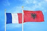 Albania and France Flag Waving in the Wind Against White Cloudy Blue ...