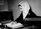 Queen Zein al-Sharaf Talal of Jordan signs the visitors book at the ...