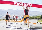 Runner crossing race finish line — people, success - Stock Photo ...