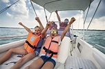 Family enjoying riding a boat on Lake Garda - Avante Insurance