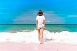Young woman haveing fun with ocean waves on a tropical beach of image ...