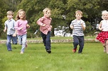 Small group young children running in park - Orlando Private School