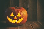 Halloween Jack O’ lantern on rustic wooden background - All Things ...