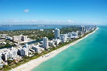 Aerial view of stunning buildings next to a white beach at Miami Beach ...