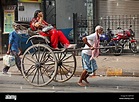 Human pulling rickshaw with passenger in Calcutta, India Stock Photo ...