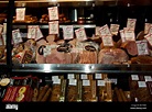 Delicatessen specialty cured meats in illuminated stainless steel Stock ...