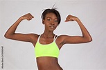 Black woman flexing her muscles Stock Photo | Adobe Stock
