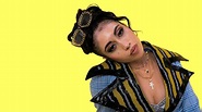 Kali Uchis Is Wearing Colorful Dress Standing In Yellow Wall Background ...