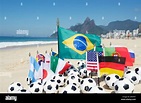 International soccer team flags with footballs on the beach in Rio de ...