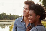 Happy mixed race couple admiring a view in the countryside - Stock ...