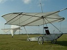 an airplane sitting on top of a grass covered field