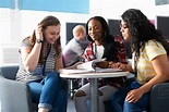 Teenage girls working together in class - Stock Photo - Dissolve