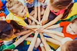 Group of children putting their hands together - Australian Fundraising