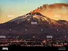 Mount Etna Volcano with smoke at dawn and the Catania city, Sicily ...