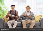 Two joyful elderly men with cups — Stock Photo © ljsphotography #133970648