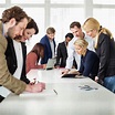 Group of business people working together at desk in office - Stock ...