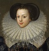 a portrait of a woman in an old fashion dress with a fan on her head