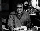 Antonio Amurri smiling with a typewriter on the table