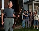 The Hmong family and Clint Eastwood as Walt Kowalski in Gran Torino (2008) directed by himself ...