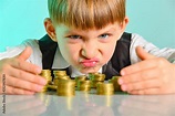 Angry and greedy child holds their money coins. The concept of greed ...