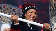 Julia Chu of the United States enters the arena with the national flag ...