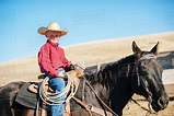 Caucasian boy riding horse on ranch - Stock Photo - Dissolve