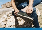Young Man Putting on or Taking Off His Shoe Stock Photo - Image of ...