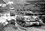An American M4A3E8 "Easy Eight" tank and other vehicles of the 11th ...